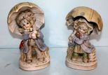 Two Porcelain Umbrella Kids Statues