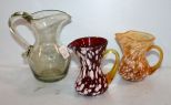 Three Blown Glass Pitchers
