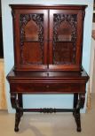 Ornately Carved Mahogany 19th Century Victorian Bookcase/Secretary Ornately Carved Mahogany 19th Century Victorian Bookcase/Secretary, top having two carved glass doors, center leather section for writing over drawer, all supported by rococo leg