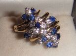 One stamped 14KT yellow gold lady's cast sapphire and diamond waterfall One stamped 14KT yellow gold lady's cast sapphire and diamond waterfall ring with a split shank with a bright polish finish. Containing: Twelve prong set round standard bril