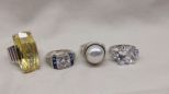 Four Stamped Sterling Silver Lady's Simulated Gemstone Rings Four Stamped Sterling Silver Lady's Simulated Gemstone Rings with a Bright Polish Finish. Sizes vary