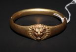 Victorian bangle bracelet. Hinged lions head bangle bracelet with three stones (one missing) marked W.M.C.