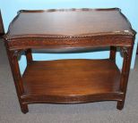 Late 19th century mahogany Chippendale style side table with ornate carving and shelf. The top edge has gadrooning and latticework carving; 31 1/2