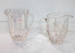 Two Clear Glass Pitchers