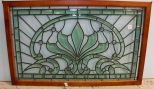 Green and Clear Stained Glass Window in Frame