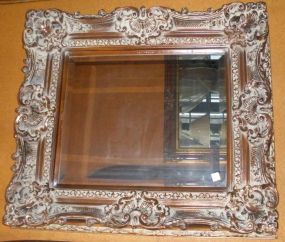 Ornate pierced carved Louis XV style framed beveled mirror