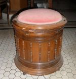 Pair of very unusual upholstered lift top walnut commodes with casters