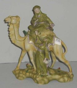 Royal Dux type hand painted man riding camel with woman walking statue