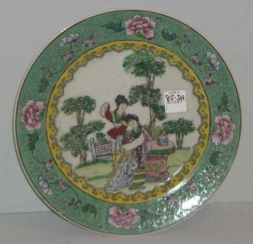 Round oriental plate with 2 ladies in garden