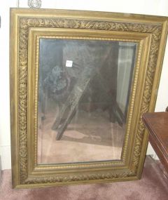 Beveled mirror in old carved gold frame