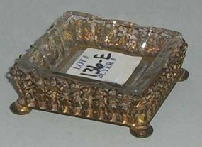 Small clear Heisey ashtray in brass footed holder