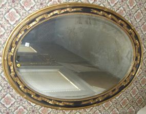 Oval Gilt and Ebonized Mirror
