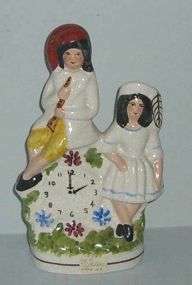 Reproduction Staffordshire Figural Boy and Girl w/Clock