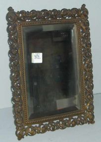 Ornate brass framed stand up mirror