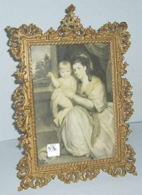 Brass ornate stand up picture frame with print of lady & baby