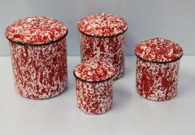 Four Red and White Enamelware Canisters