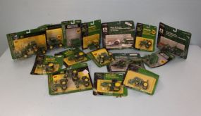 Various John Deere toys, sprayers, wagons, and tractors