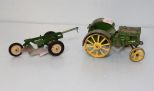 Small John Deere tractor and attachment