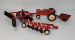 Small red tractor and three attachments