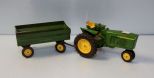 Small green tractor and attachment