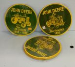 Twelve 12'' round John Deere metal signs