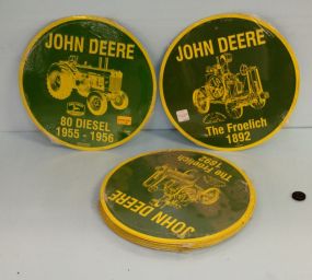 Twelve 12'' round John Deere metal signs