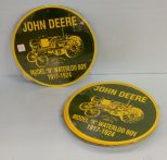 Twelve 12'' round John Deere metal signs