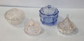 Four Various Size Covered Glass Jars 