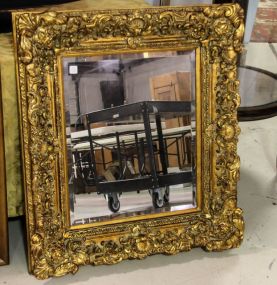 Beveled Mirror with Heavily Carved Gold Frame