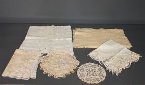 Group With Linen Doily, Tablemats and Tablecloth Description