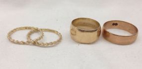 Four stamped 10KT yellow gold lady's cast bands