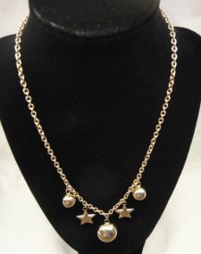 One stamped 14KT yellow gold lady's star and moon necklace
