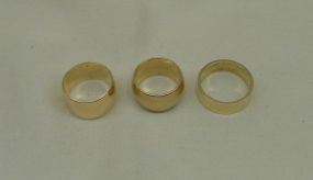 Three stamped 14KT yellow gold lady's band