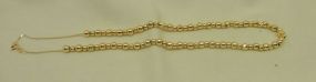 One Stamped 14KT Yellow Gold Lady's Beaded Necklace