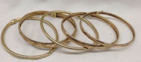 Five stamped 10KT yellow gold lady's Bangle bracelets