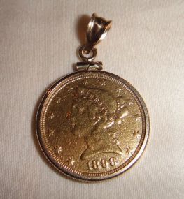 One 21KT and 14KT yellow gold lady's die struck gold coin pendant with a coin edge mounting
