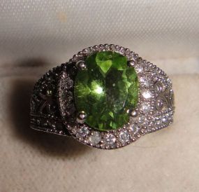 One stamped 14KT white god lady's peridot and diamond ring