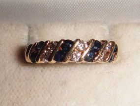 One stamped 14KT yellow gold lady's cast sapphire and diamond band