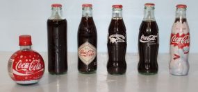 Six Coke Bottles