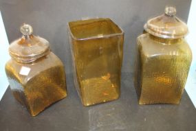 Two Amber Colored Glass Covered Jars and Amber Vase Jars 11 1/2