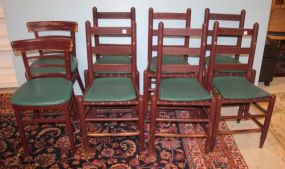 Seven Ladder Back Chairs and One Curved Back Chair
