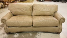Light Tan Sofa with Rolled Arms with brad detailing;