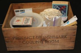Wood Crate with Small Bat, Cards, Plastic Seale-Lily One Gallon Container, Dumas Milner Chevrolet Co., Bottle Opener, Crochet Bag, Marbles, and Mini Puzzle.