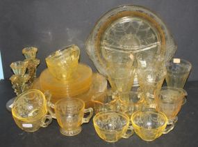 Collection of Yellow Depression Glass candlesticks, plates, cups, divided dishes, glasses, and creamer/sugars.