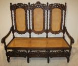 Victorian Oak Carved Settee Ornate Victorian oak leaf, barley twist, cupid carved settee in original oak finish, cane seat, and back also has embossed velvet cushion; 63