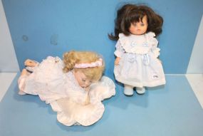 Two Dolls and One Reclining On Pillow