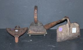 3 Pieces of Cast Iron iron with base, hoe, and another iron base.