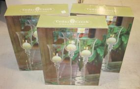 Three Boxes of Cedar Creek Glass Candleholders Three Boxes of Cedar Creek Glass Candleholders.