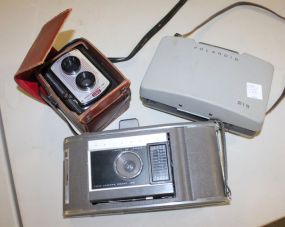 Three Vintage Cameras Two Polaroids (215,J66) Reflex II in original case.