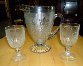 Pitcher and two glasses with flowers